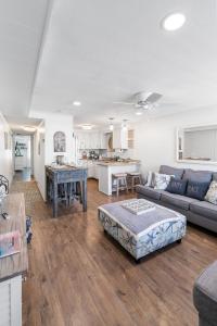 a living room with a couch and a table at Ocean Block Condo 100 Steps From the Beach in Ocean City