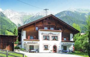 a large house with mountains in the background at Nice Apartment In Pettneu Am Arlberg With 2 Bedrooms And Wifi in Pettneu am Arlberg