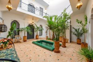 a courtyard with a swimming pool and plants at Riad Des Sables-Exclusive -4 Suites -Swimming Pool in Marrakesh