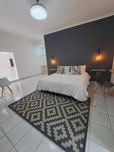 a bedroom with a large bed and a rug at 2 On Greeff in Graaff-Reinet