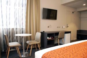 Una televisión o centro de entretenimiento en Mercure Orange 75 fotos más