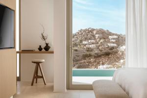a bedroom with a view of a mountain at Mykonos Flow - Super Paradise in Super Paradise Beach