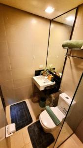 a small bathroom with a toilet and a sink at Lushfield Boracay Guest House in Boracay