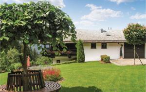 a yard with a bench in front of a house at Amazing Home In Kitzbhel With 5 Bedrooms, Sauna And Internet in Haselwand