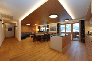 a kitchen and living room with a table and chairs at Astergut Boutique Apartment in Saalbach Hinterglemm