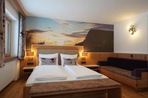 a hotel room with a bed and a couch at Astergut Boutique Apartment in Saalbach Hinterglemm