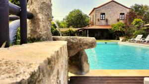 a swimming pool in front of a house at Quinta Padre Lobo in Santa Maria Da Feira