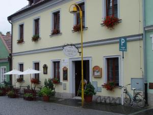a white building with a sign in front of it at Hotel Galerie in Třeboň