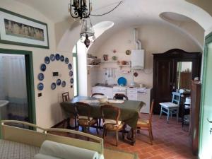 a dining room with a table and a kitchen at Casa Nana' in Carpignano Sesia