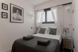 a bedroom with a bed with two towels on it at Palais Des Iles - La Croisette in Cannes