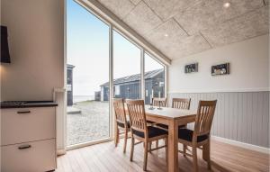 a kitchen and dining room with a table and chairs at Lille Rn in Nyborg