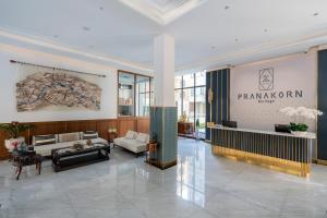 a large lobby with a large sign on the wall at Pranakorn Heritage Hotel in Bangkok