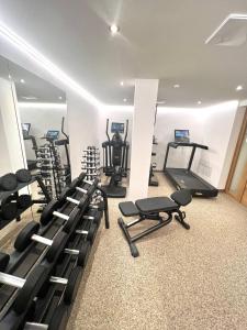 a gym with a row of treadmills and machines at Hotel-Skischule Krallinger in Obertauern