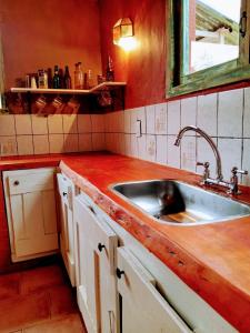 a kitchen with a sink and a wooden counter top at Mi Casa Tu Casa in Lago Puelo
