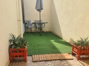 a room with a table and two potted plants at بيت الياسمين2 in Al Madinah