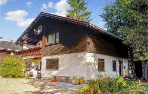 a small house with a black roof at Amazing Apartment In Schetteregg With House A Mountain View in Egg