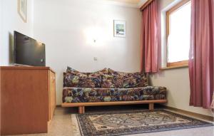 a living room with a couch and a flat screen tv at Amazing Apartment In Kappl With 1 Bedrooms in Kappl