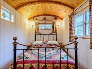 a bedroom with a bed with a wooden ceiling at 1 Bed in Ironbridge 80727 in Leighton