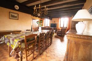 a dining room with a table and chairs at Ferme Bressane - 4 chambres in Saint-Étienne-du-Bois