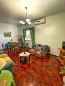 a living room with a couch and a table at Departamento peatonal Mendoza in Mendoza