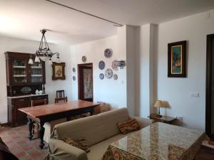 a living room with a table and a couch at Chalet Rafael Constantina in Constantina