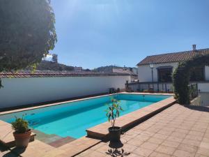 a swimming pool in front of a house at Chalet Rafael Constantina in Constantina