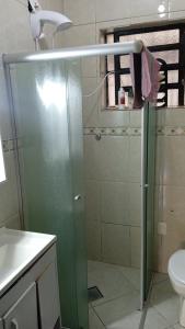 a shower with a glass door in a bathroom at Pousada AME in Caxias do Sul