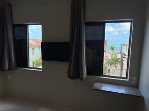 two windows in a room with a view at Iracema Mar Hotel in Fortaleza