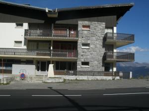 a building with balconies on the side of a street at Le petit coin de Montagne in Saint-Lary-Soulan