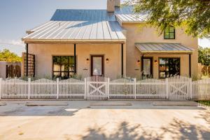 a white picket fence in front of a house at GARDENS OF BARONS CREEK UNIT A in Fredericksburg