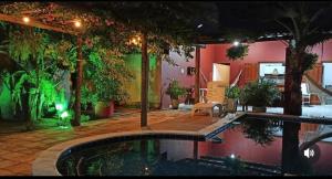 a house with a swimming pool in the middle of a yard at Casa Villa Mariah - São Miguel dos Milagres - PATACHO, PORTO DE PEDRAS in Pôrto de Pedras