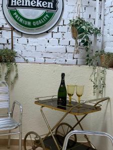 a table with a bottle and two glasses on it at Apartamento familiar 3 habitaciones Alcala in Madrid