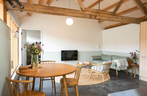 a living room with a table and chairs and a couch at Ladymeade in Dorchester