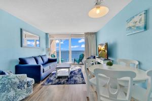a living room with a couch and a table at Bay Watch Resort 1203 - Perfect Oceanside Getaway in Myrtle Beach