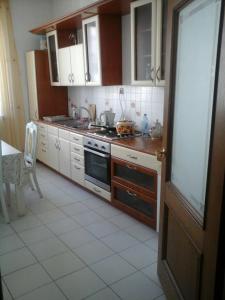 a kitchen with wooden cabinets and a stove top oven at Kaldyakova in Astana