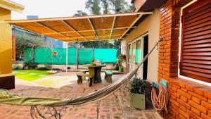 um pátio com uma rede de descanso anexada a uma casa em ALOJATECARLOSPAZ Hermoso & Completo Dpto a pasos del Río y Parrillas em Villa Carlos Paz