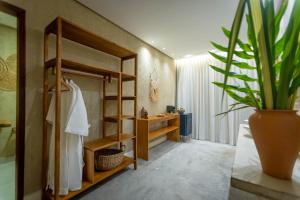 a bathroom with a shelf and a sink and a plant at Pousada Mirai in São Miguel dos Milagres