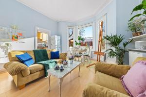 a living room with two couches and a table at Artist's Bright Hampstead Heath Village 2 bed in London