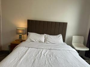 a bedroom with a large bed with a wooden headboard at Private room in Glasgow City Center in Glasgow