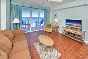 a living room with a couch and a flat screen tv at Wyndhams Ocean Walk Resort in Daytona Beach