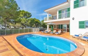 a swimming pool in front of a house at Villa Mirador A by Sonne Villas in Cala Galdana