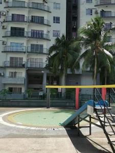 an empty playground in front of a building at Happy Villa (Marina View Villas) in Port Dickson
