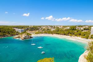 an aerial view of a beach with boats in the water at Villa Mirador A by Sonne Villas in Cala Galdana