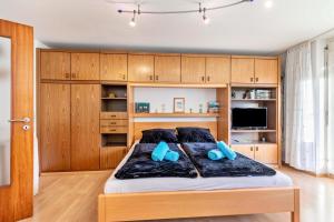 a bedroom with a large bed with wooden cabinets at Studti 134 in Beuren +7 photos