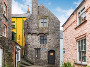 an old stone building with a yellow house at 2 Bed in Tenby 83211 in Tenby