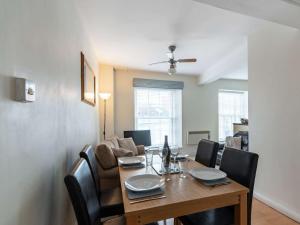 a dining room with a wooden table and chairs at 2 Bed in Tenby 83211 in Tenby