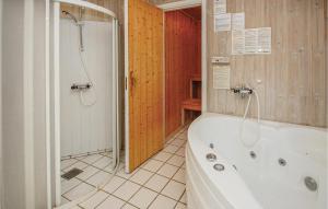 a bathroom with a bath tub and a shower at Holiday Home Hvedemarken Sjølund Iii in Hejls