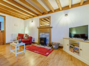 a living room with a fireplace and a flat screen tv at 3 Bed in Appleby 86428 in Long Marton