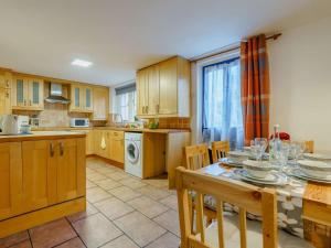 a kitchen with a table and chairs and a kitchen with a table and a table at 3 Bed in Appleby 86428 in Long Marton