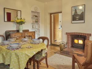 a dining room with a table and a fireplace at 3 bed in Keswick SZ422 in Applethwaite